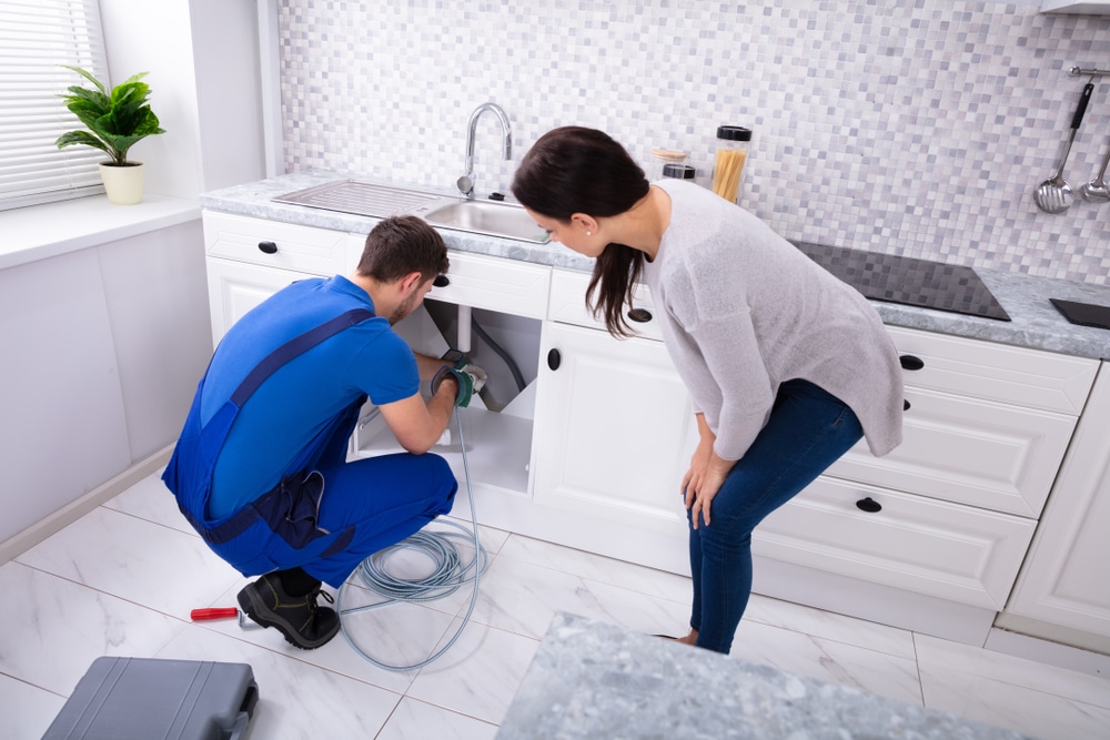 A plumber inspecting plumbing system